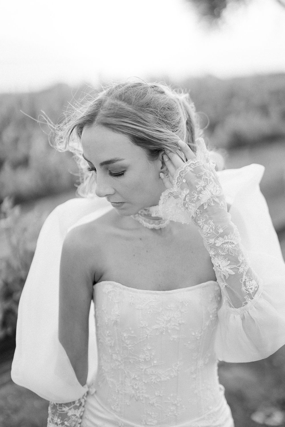 Ethereal black and white bridal portrait featuring delicate lace veil and strapless gown.