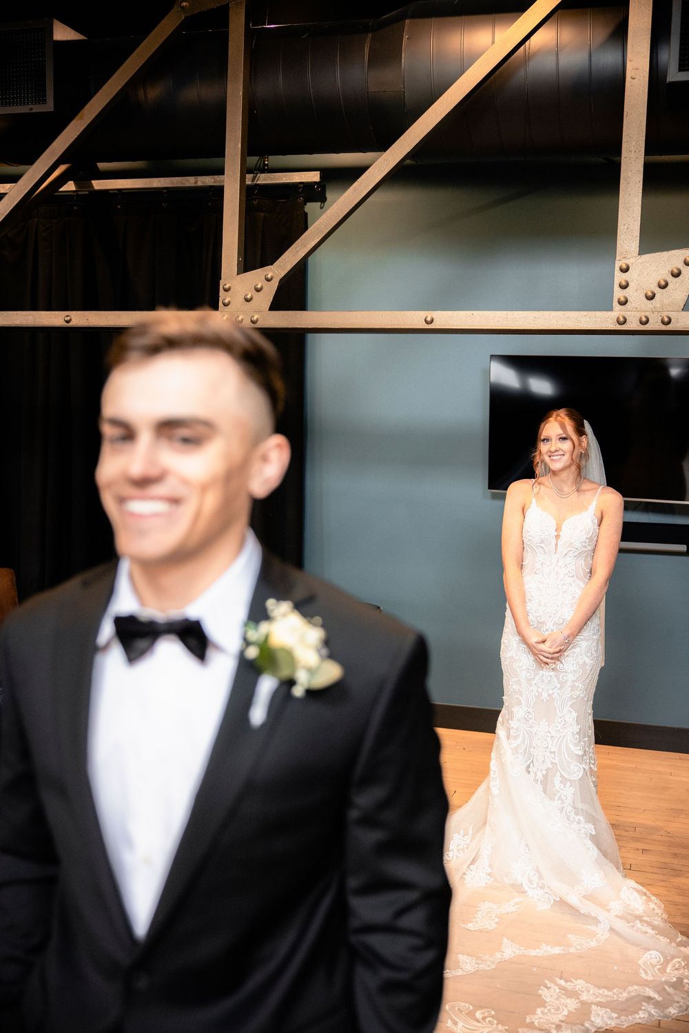A first look moment captured between a couple in formal wedding attire.