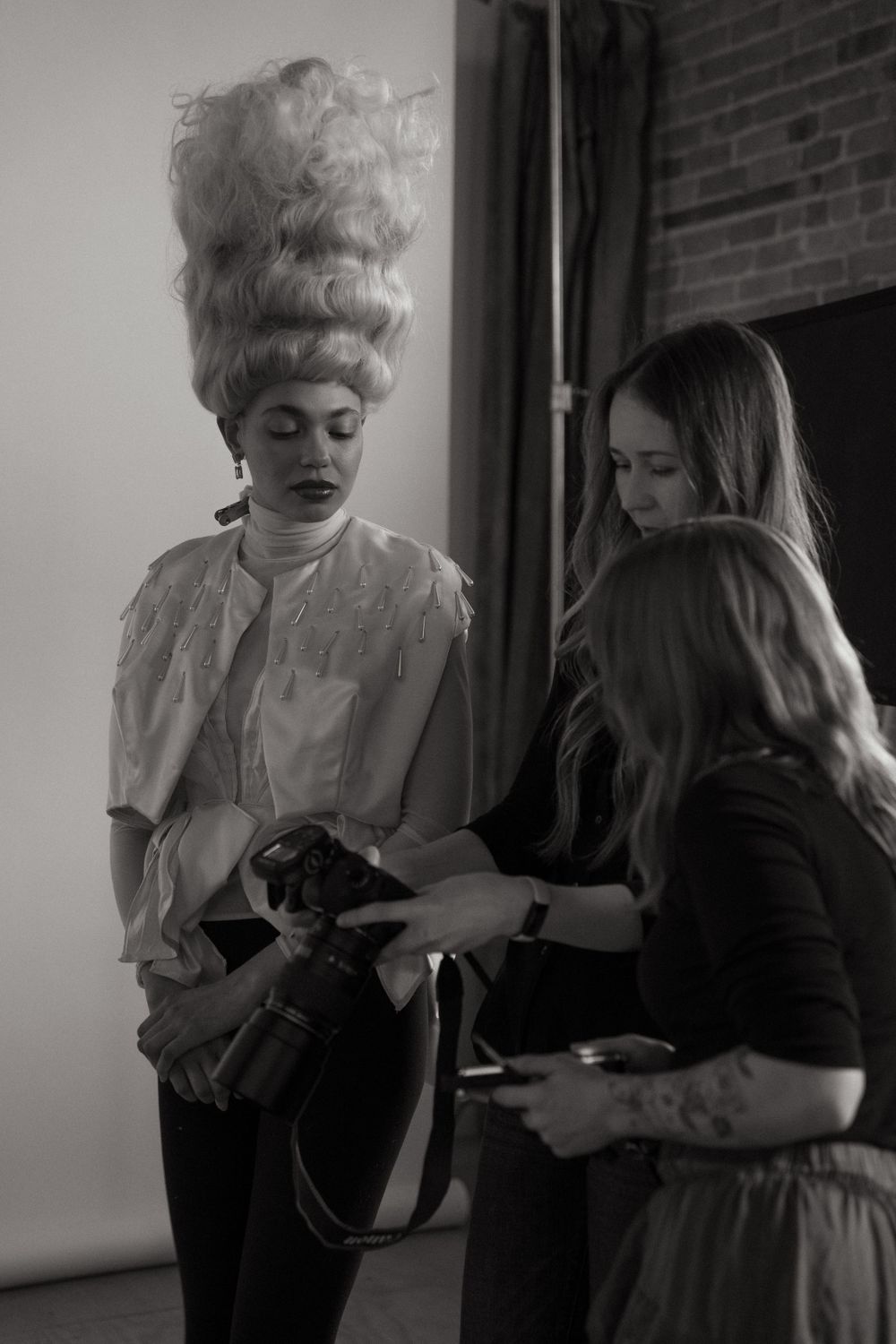 Fashion shoot featuring dramatic vintage-inspired hairstyling in monochrome.