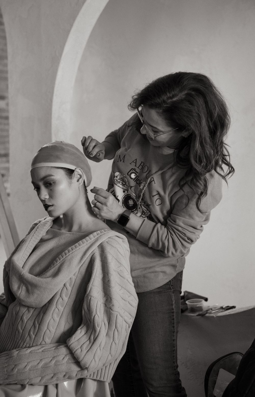 Behind-the-scenes photo of stylist working on a fashion shoot in black and white.