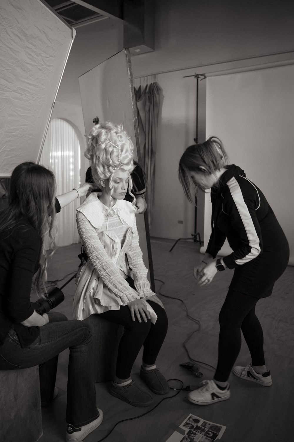 Behind the scenes photo shoot preparation in studio with lighting equipment.