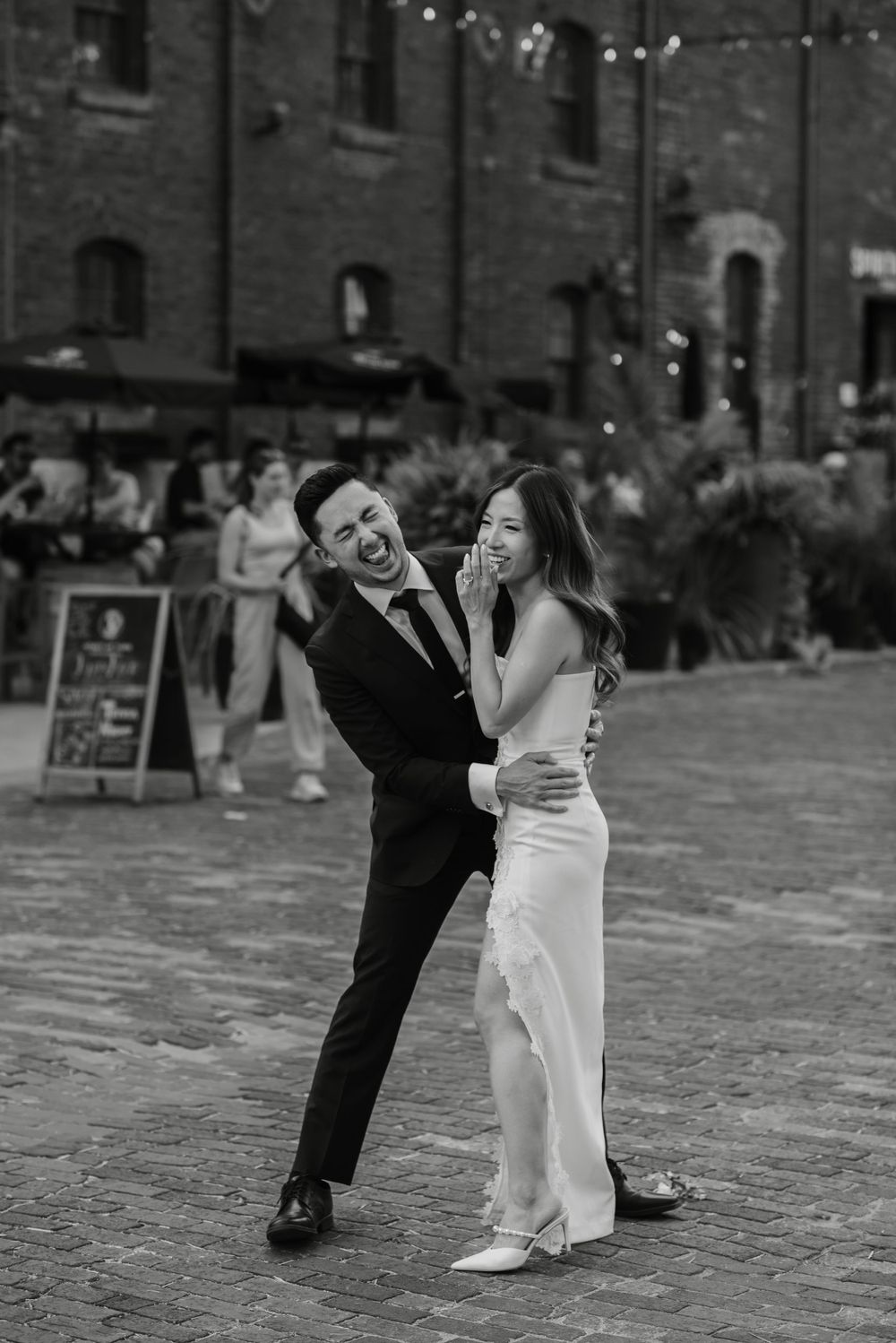 Toronto couple in Black and white for wedding photos smiling in the distillery district, captured by Jess GC Photography