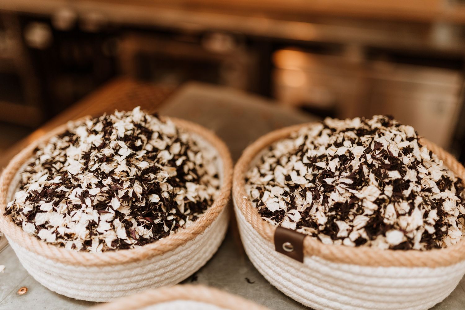 Two chocolate cream pies topped with shaved chocolate and whipped cream on rustic wooden surface.