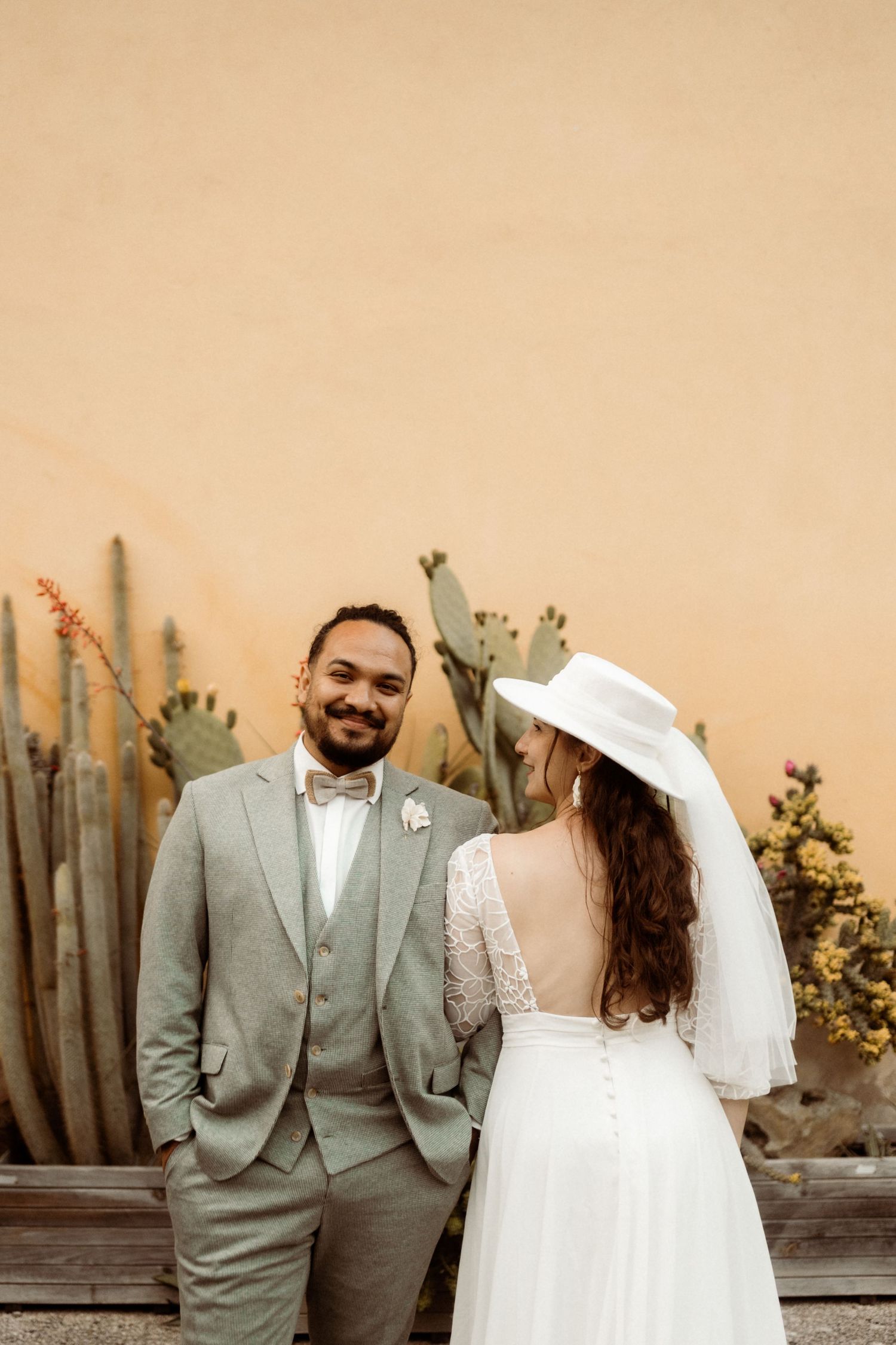 A desert garden wedding ceremony with succulents and cactus plants creates a romantic desert backdrop.