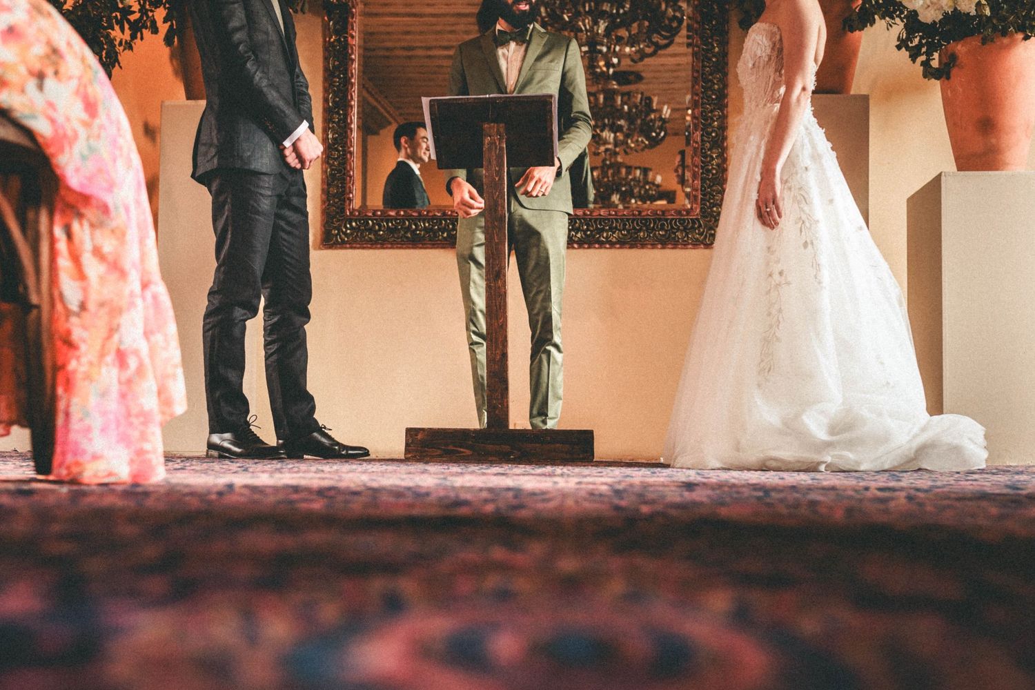 Wedding ceremony captured from floor level showing formal attire and decor.