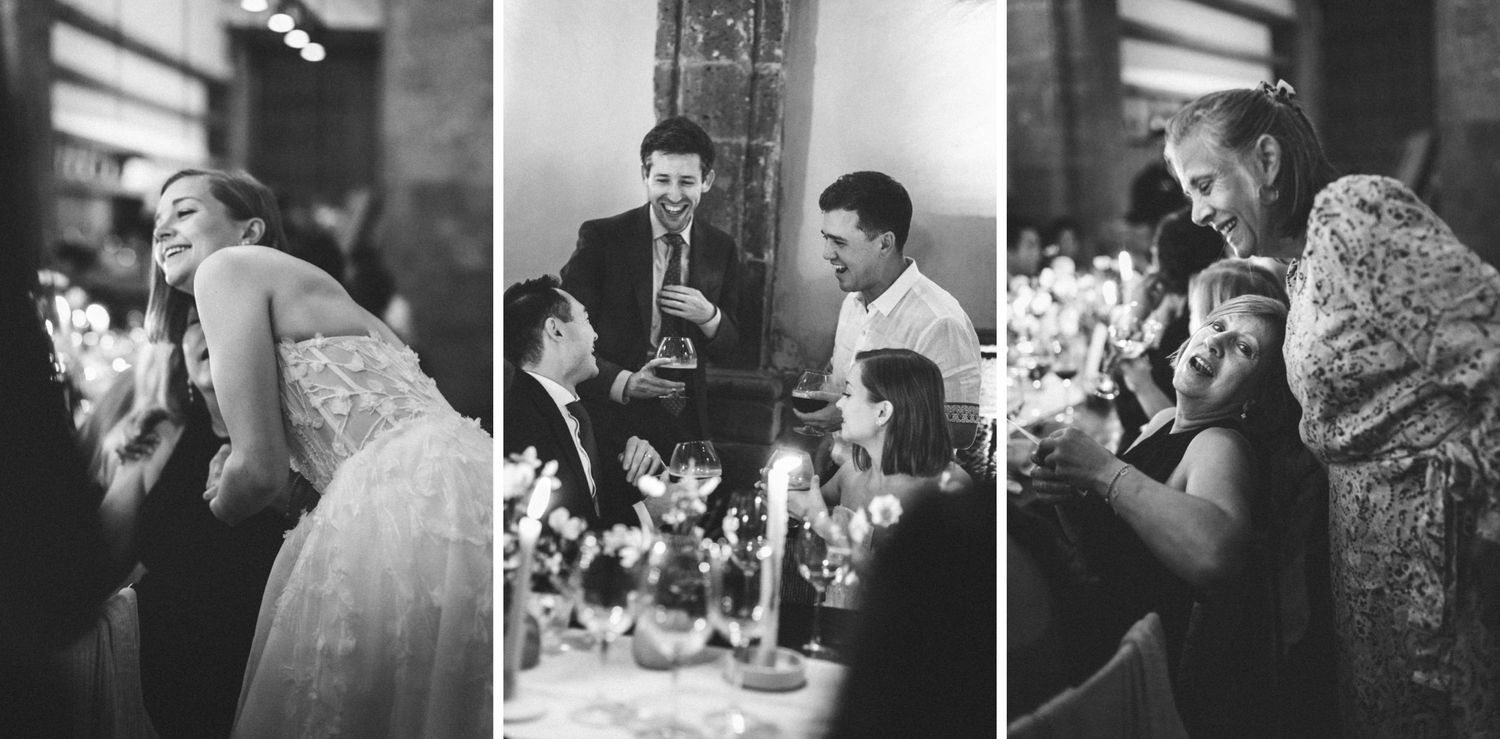 Wedding guests enjoying conversation and drinks during an intimate indoor reception celebration.