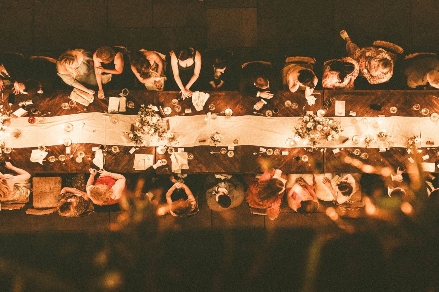 Row of decorative candles creating a warm glowing ambiance against a dark background.