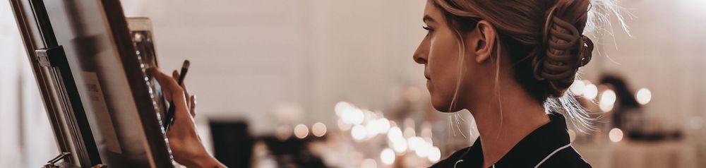 Side profile of someone wearing headphones while working in a recording studio.