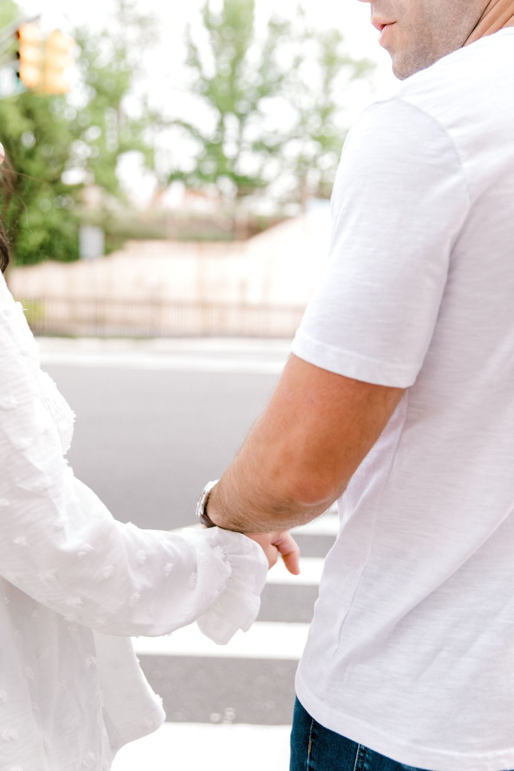 Engagement photo of couple smiling at each other in Cranford, NJ at golden hour.