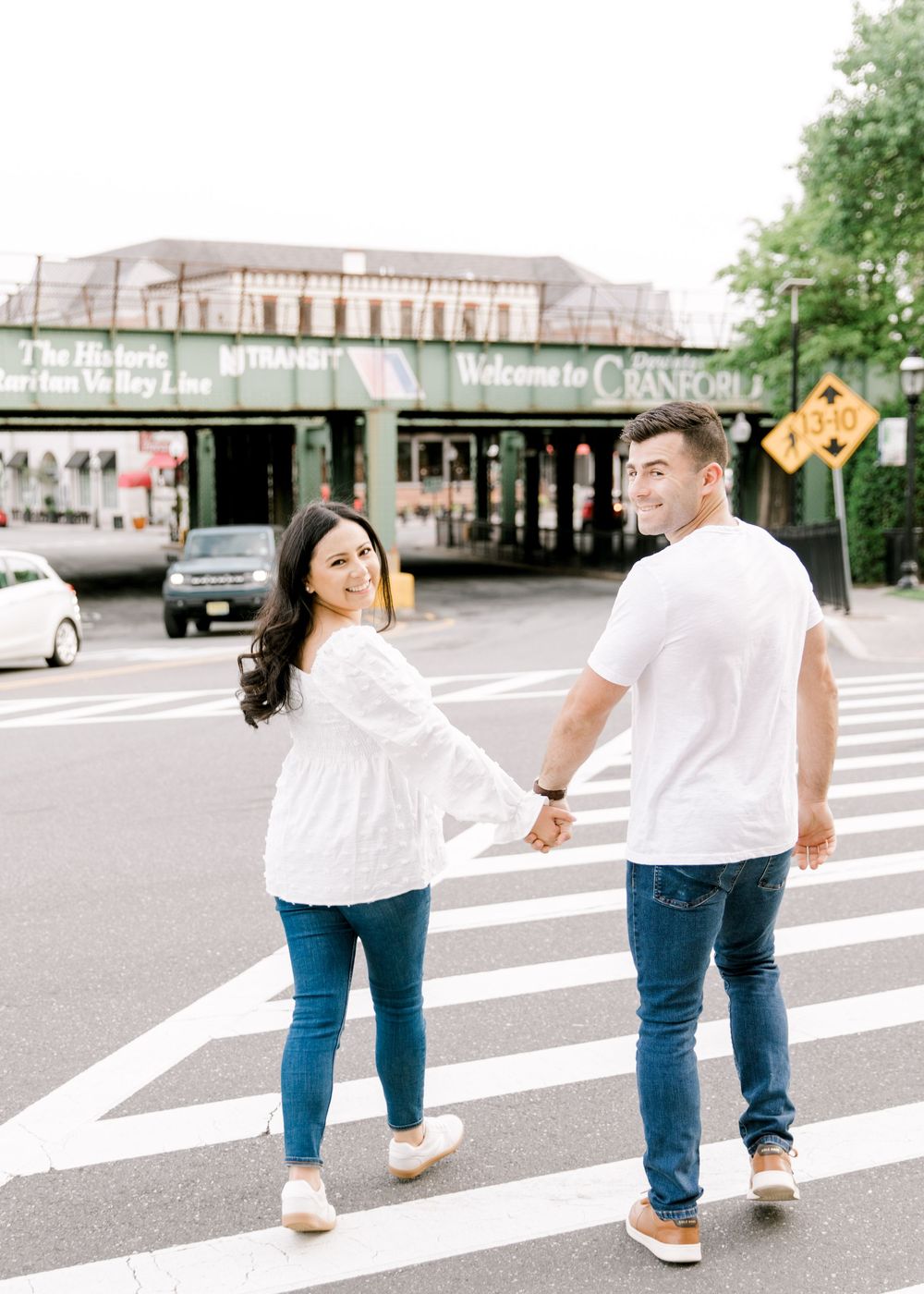 Engagement photo of couple smiling at each other in Cranford, NJ at golden hour.