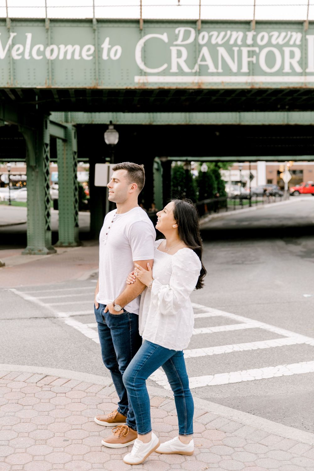 Engagement photo of couple smiling at each other in Cranford, NJ at golden hour.