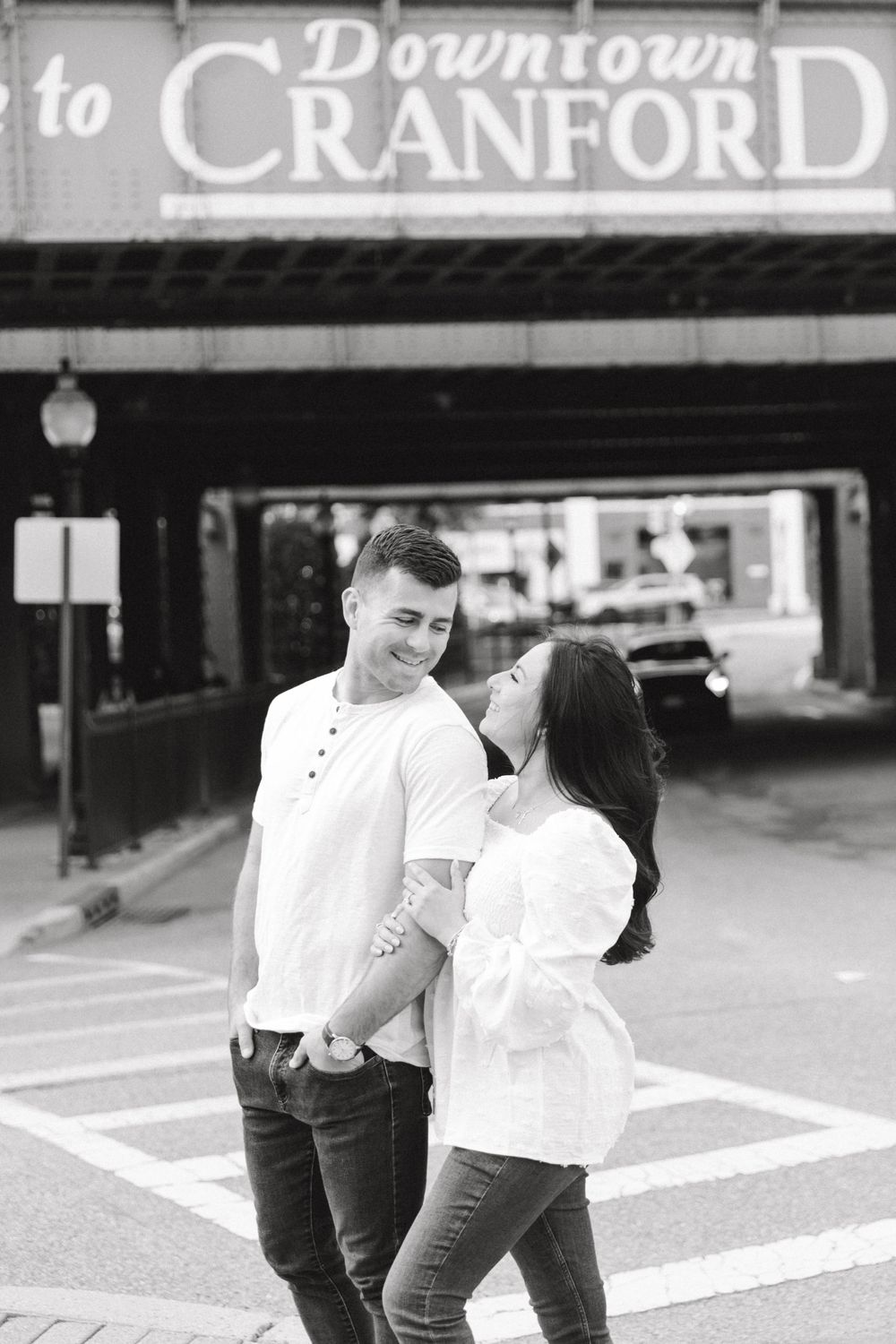 Engagement photo of couple smiling at each other in Cranford, NJ at golden hour.