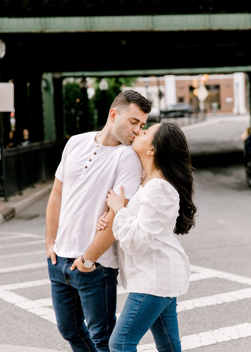 Engagement photo of couple smiling at each other in Cranford, NJ at golden hour.