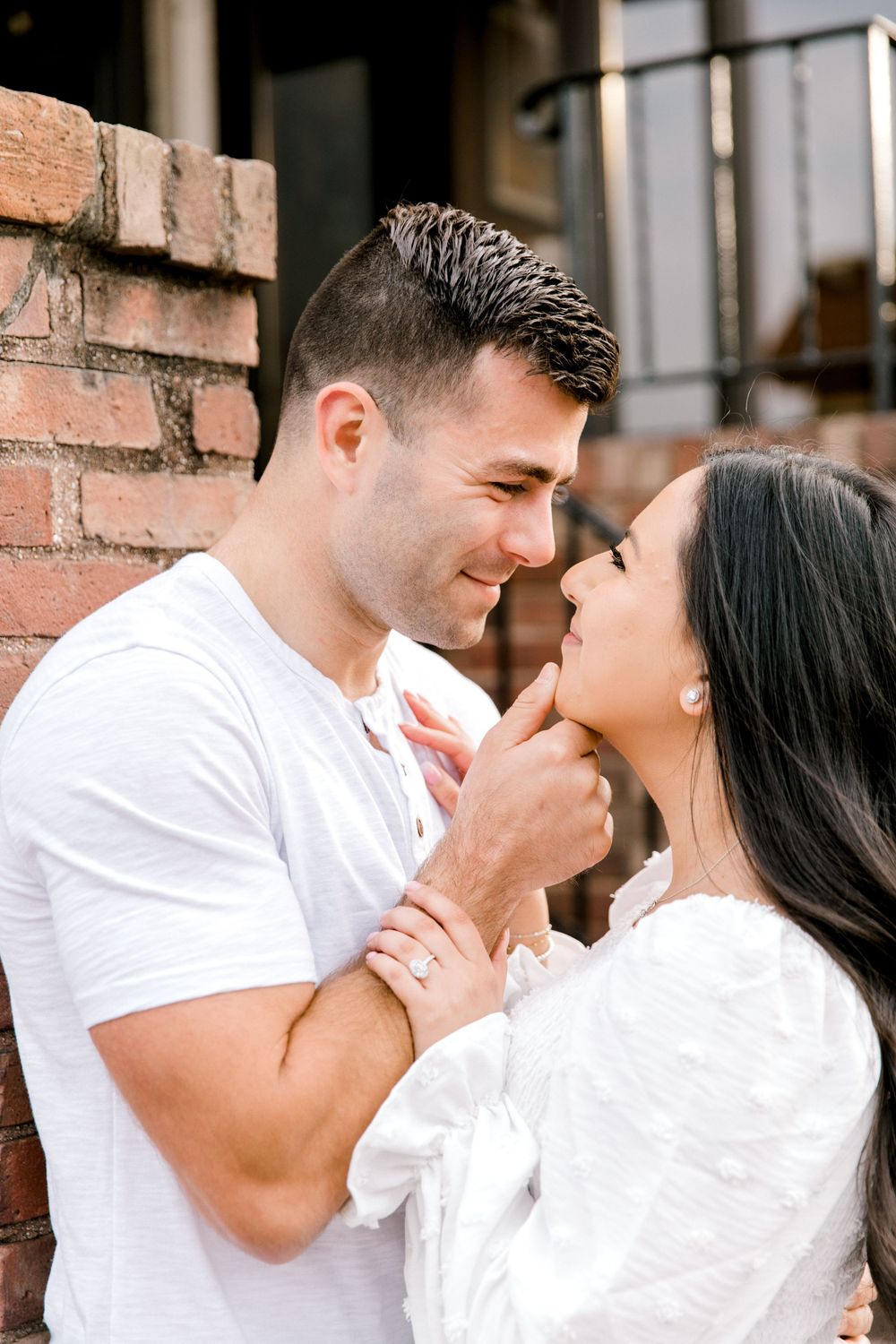 Mariela and Nick walking hand-in-hand down a tree-lined street in Cranford, New Jersey.