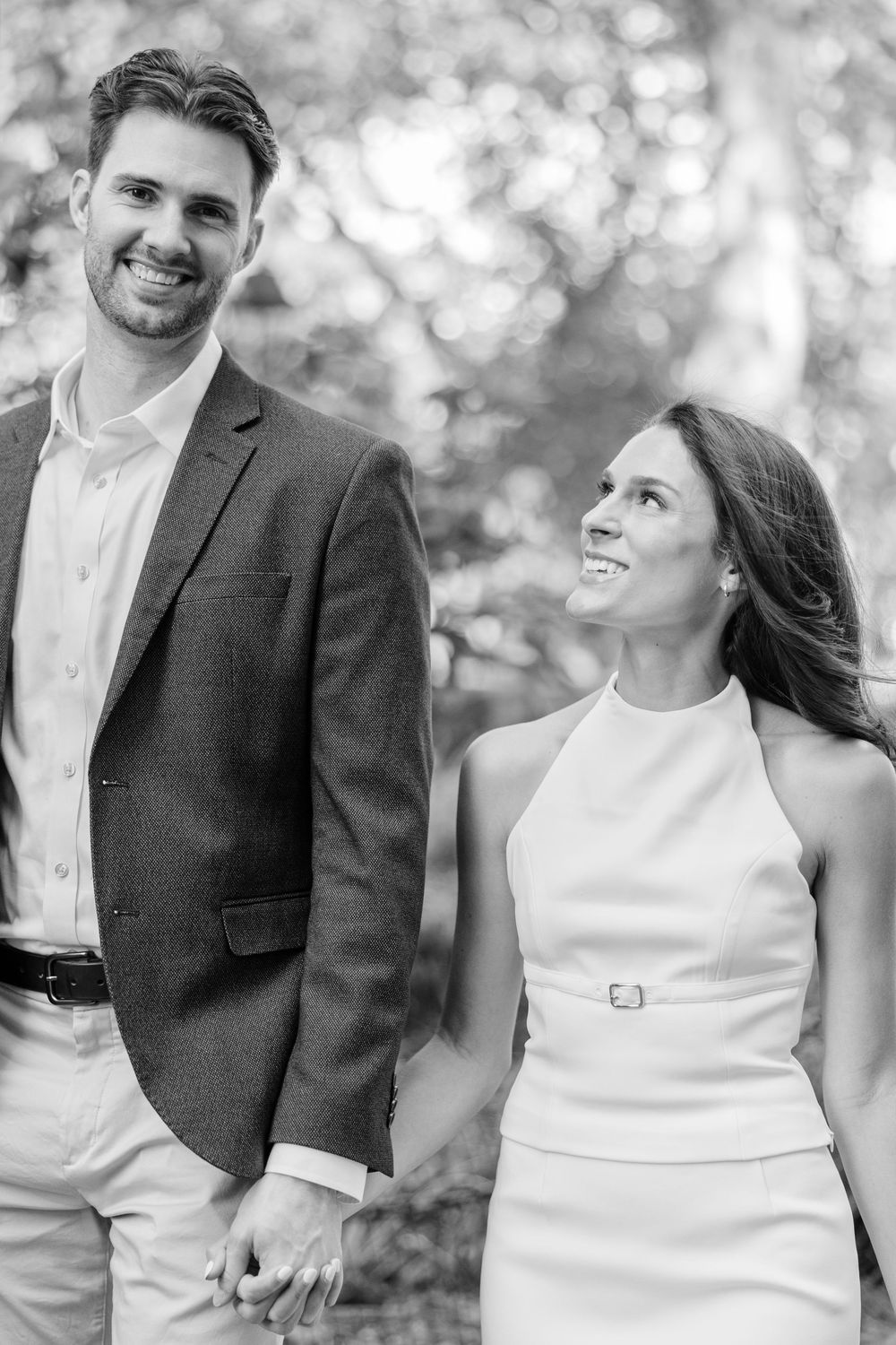 Black and white portrait of couple in formal wear smiling outdoors in New York City.