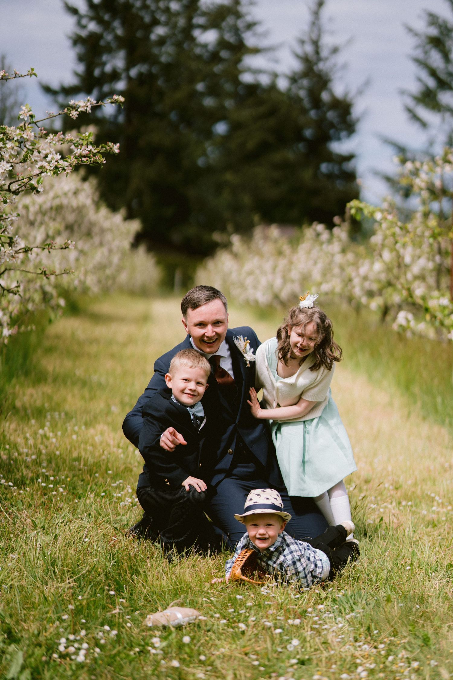 A playful outdoor photo session with kids and a grown-up in a field of wildflowers.