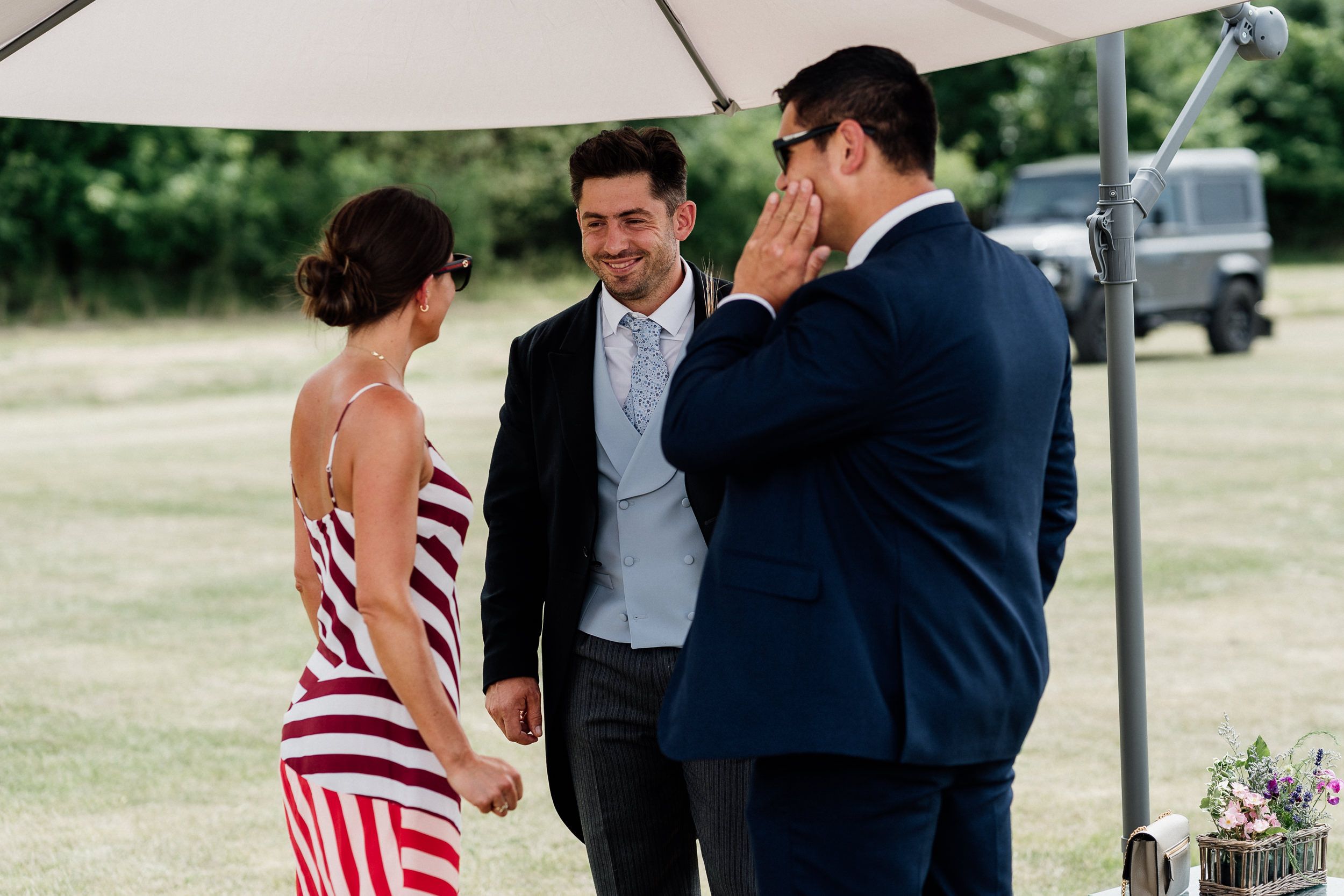 Wedding couple sharing tender moments outdoors during their special celebration in the garden.