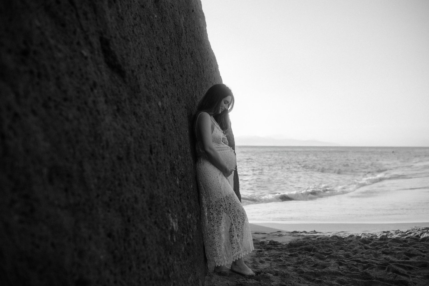 Black and white maternity photo showing silhouette against ocean backdrop. Tenerife Wedding Photographer at Playa del Duque, Adeje.