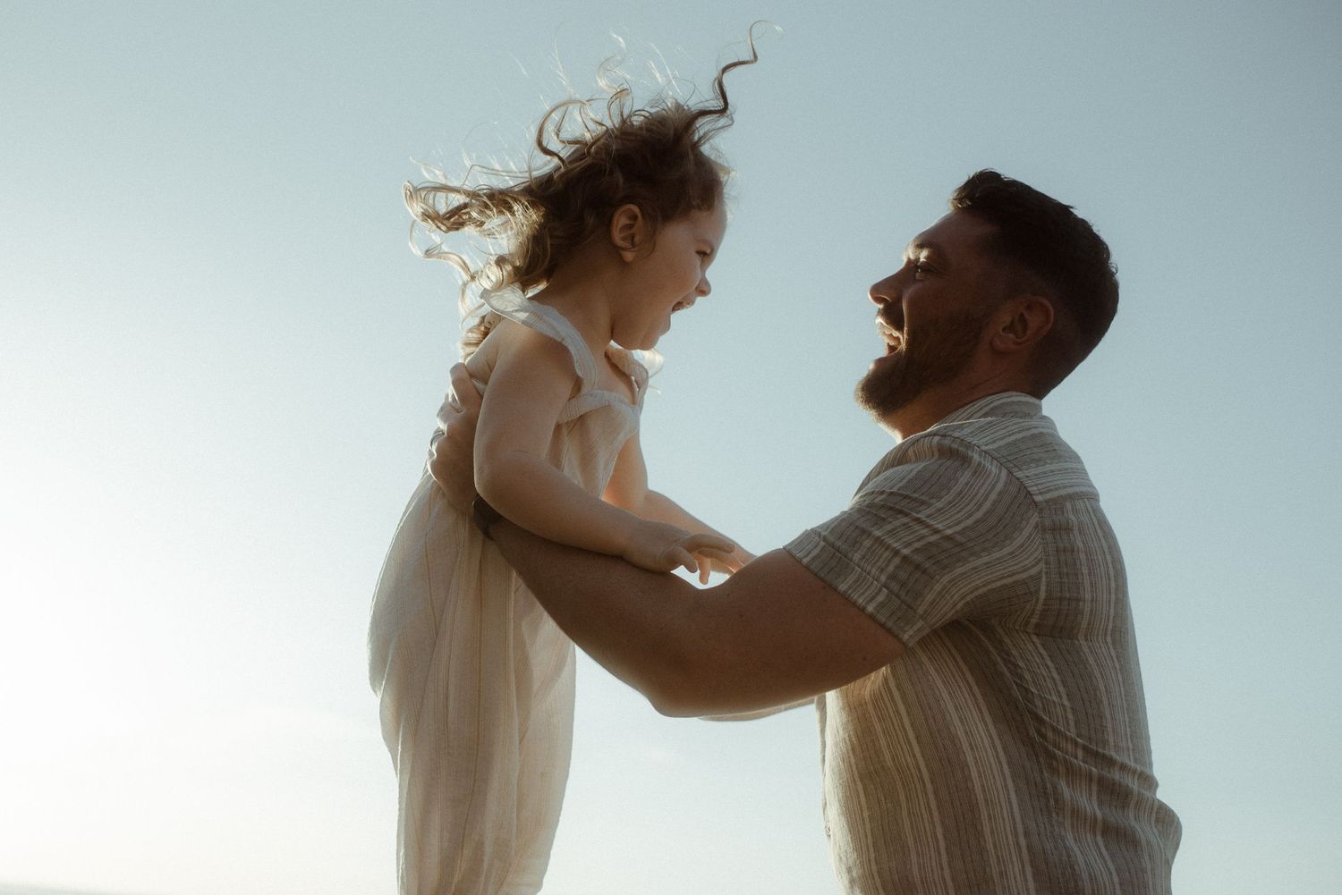Playful interaction against sunset beach background. Tenerife Wedding Photographer at Playa del Duque, Adeje.