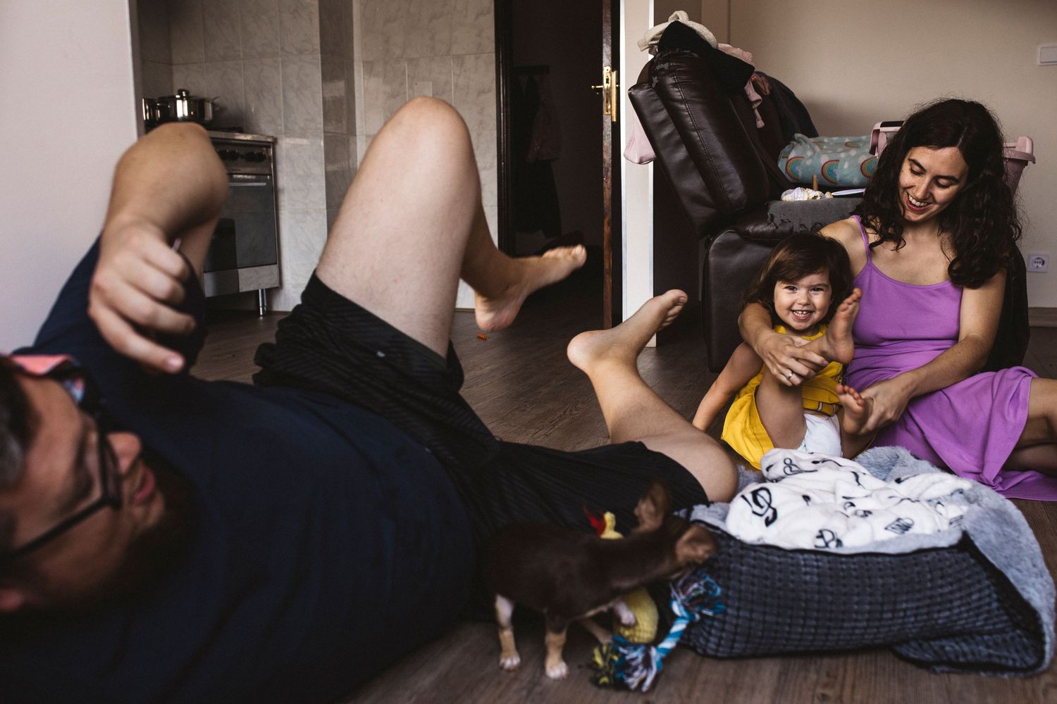 A sweet domestic scene shows two people lying down and relaxing in a casual home setting.