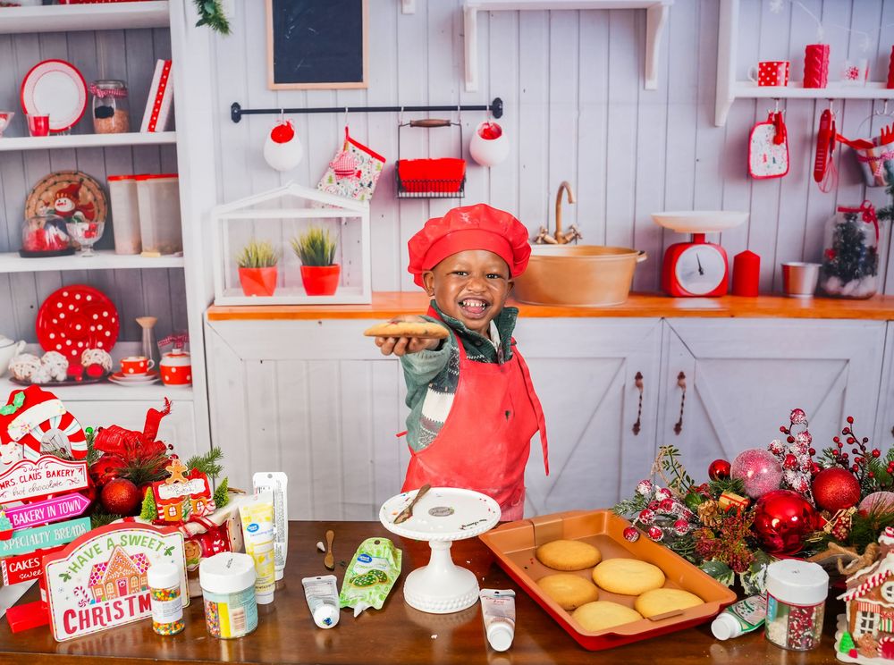 A festive holiday kitchen decorated in red and white with baking supplies, cookies, and Christmas ornaments.