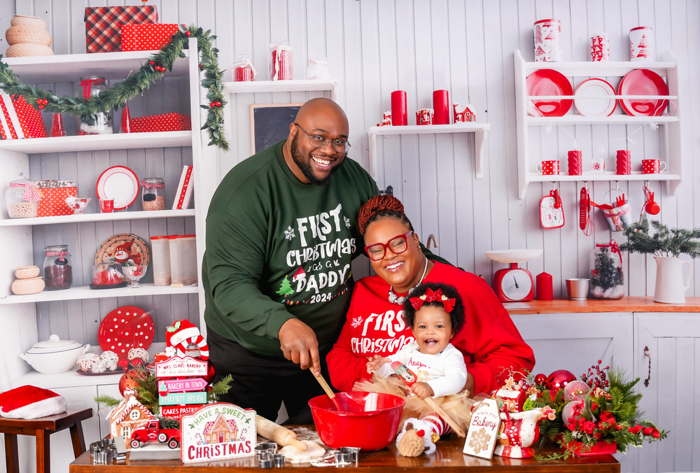 Holiday craft scene showing people working together on red and white themed decorations in a festive workshop setting.