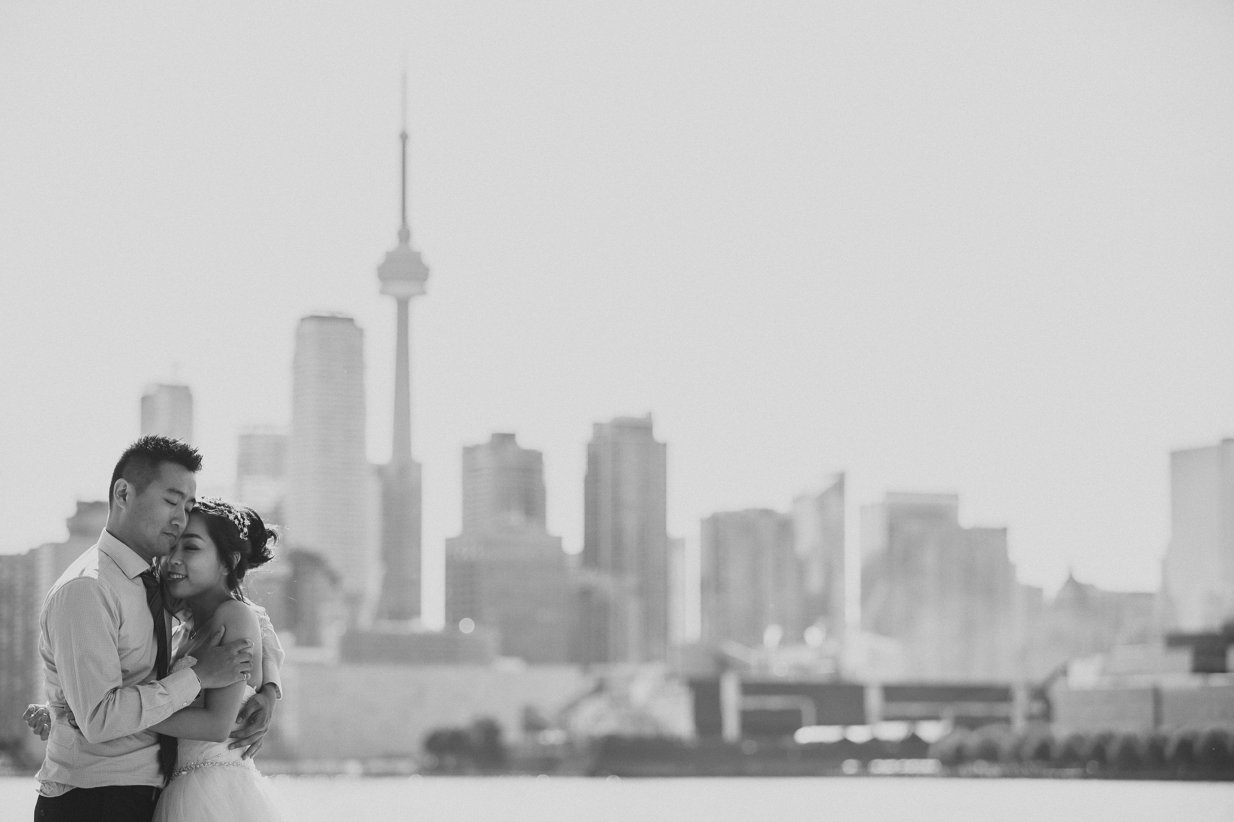 Toronto skyline with CN Tower in background of romantic photoshoot.