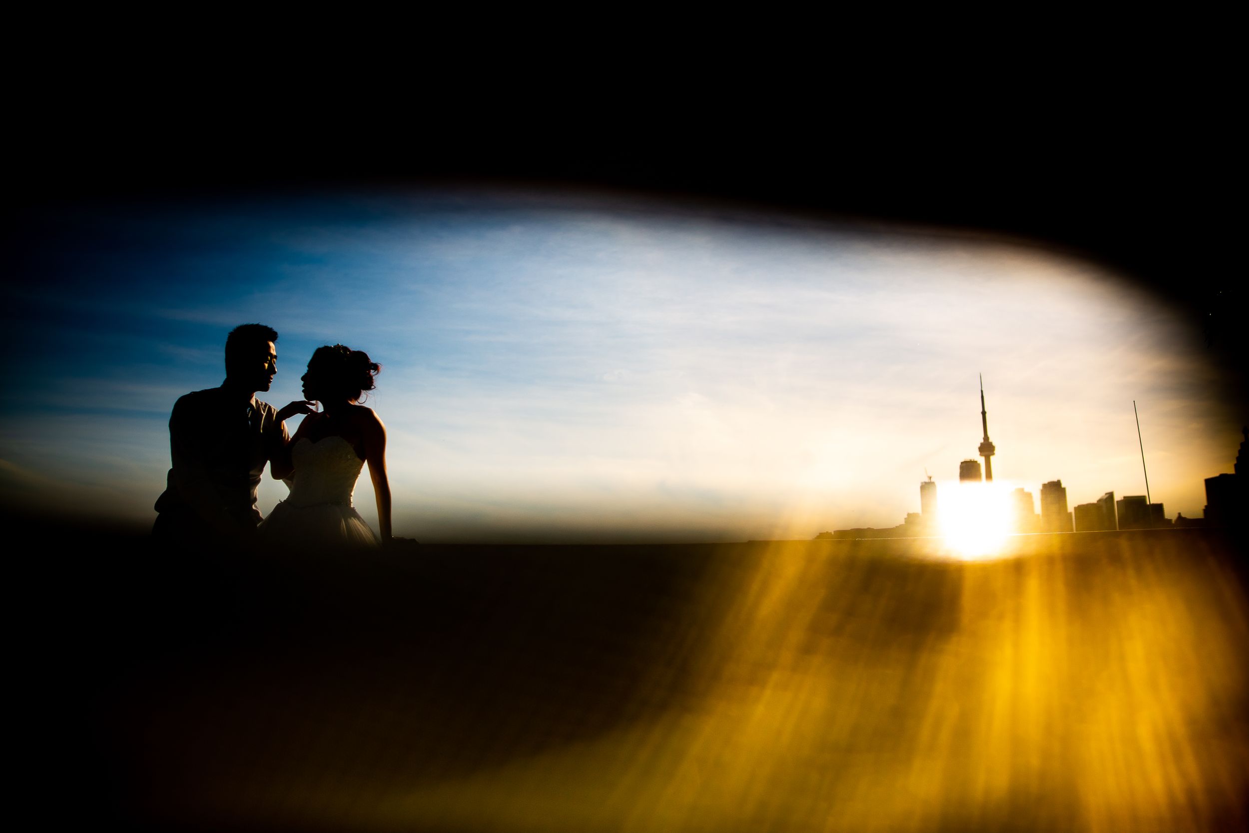 Artistic silhouette photo with city skyline and dramatic sunset lighting.