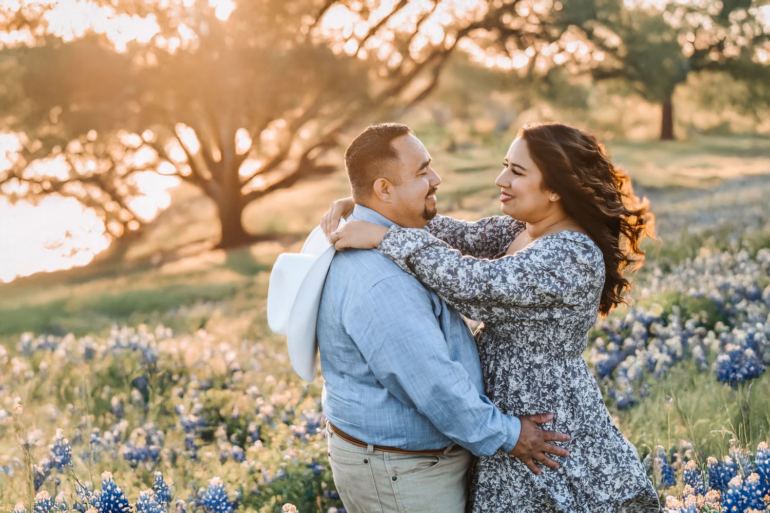 Romantic lakeside portrait with wildflowers in the foreground and love written all over their faces