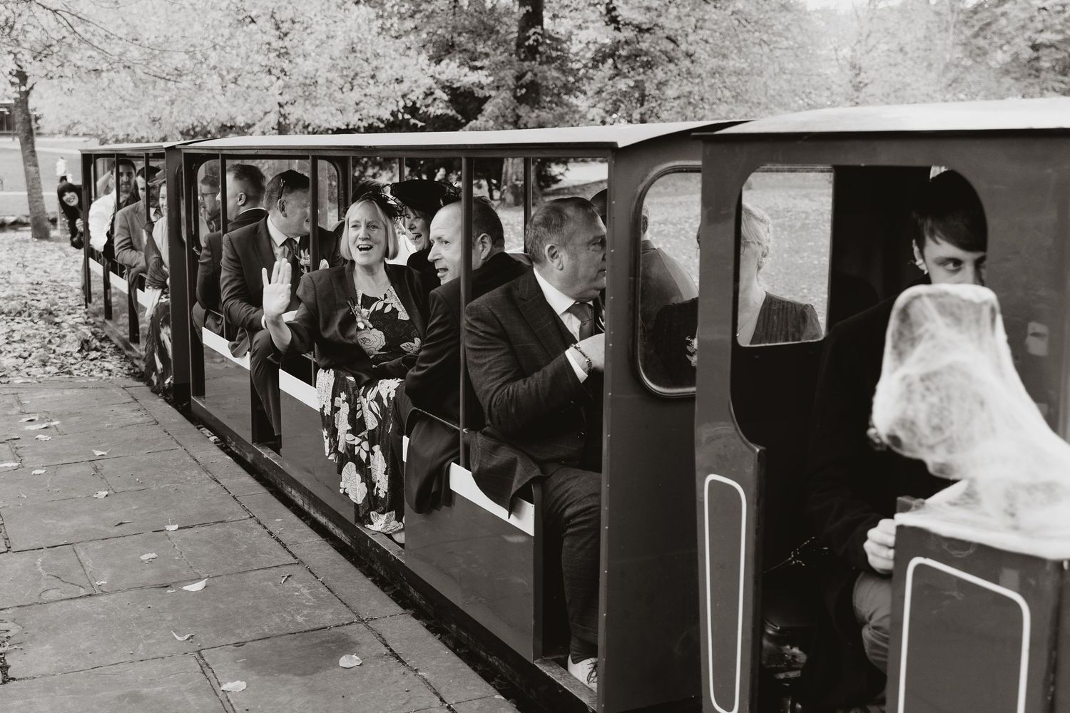 Wedding guests on a mini train at wedding reception in Buxton Park.