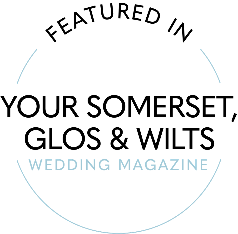 A simple circular logo design for a wedding magazine featuring text in light blue and black colors.