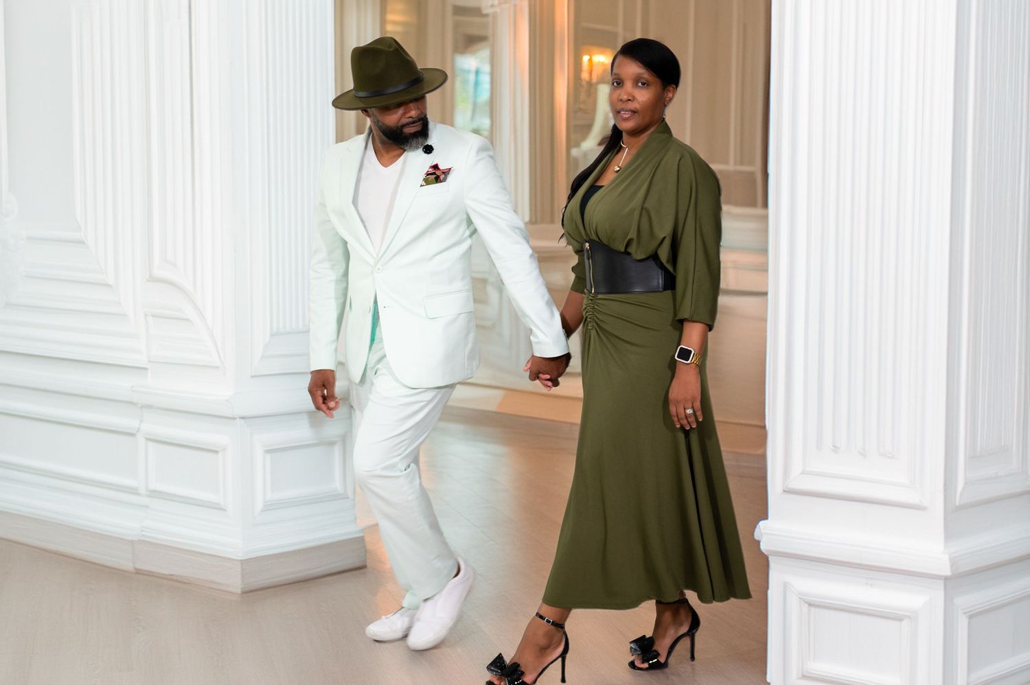 The husband and wife wedding photographers, Solomon & Naomi, walking through the halls of the luxurious Breakers in Palm Beach.