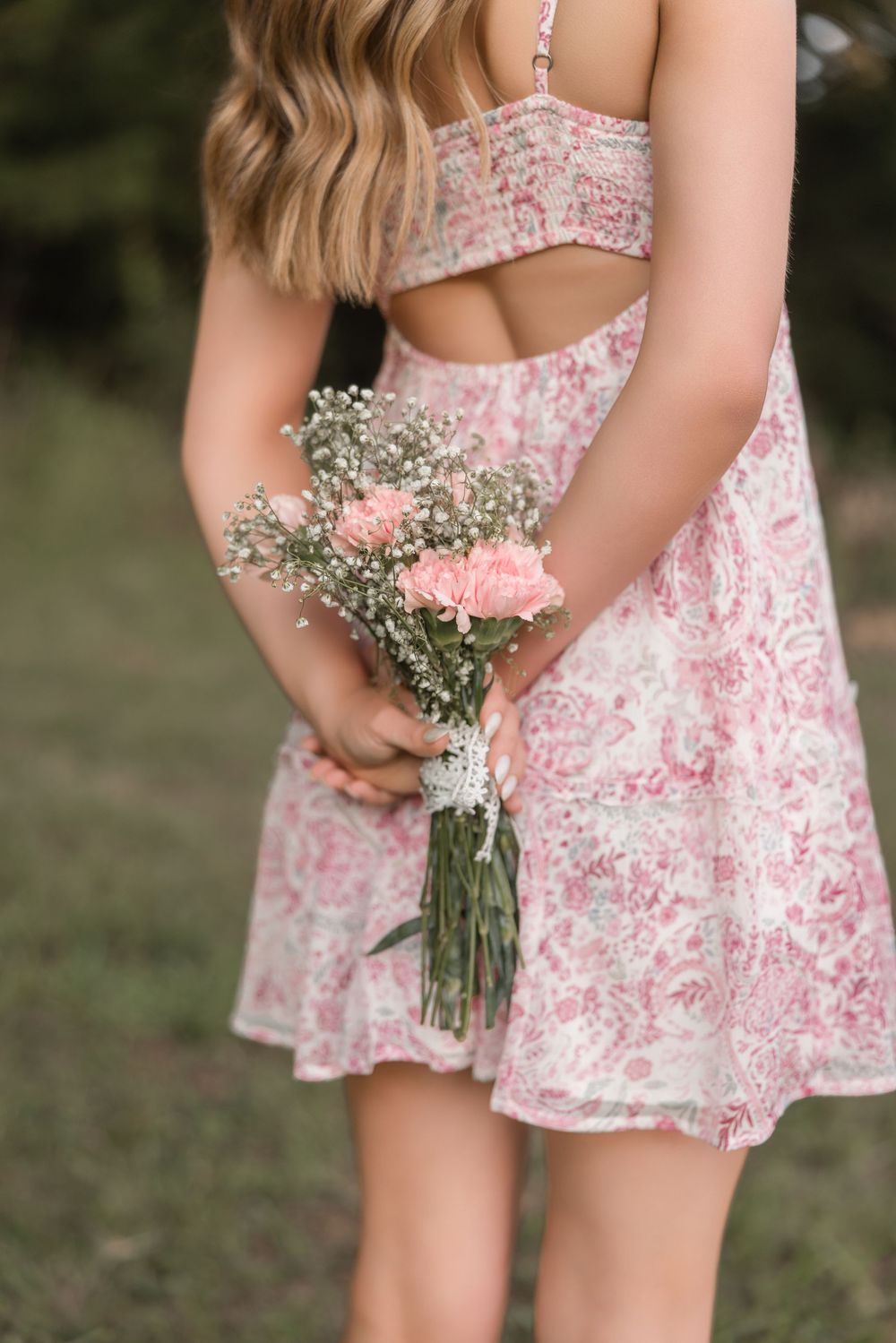 Eight sequential photos show a child in a pink floral dress holding a delicate bouquet of baby's breath flowers.