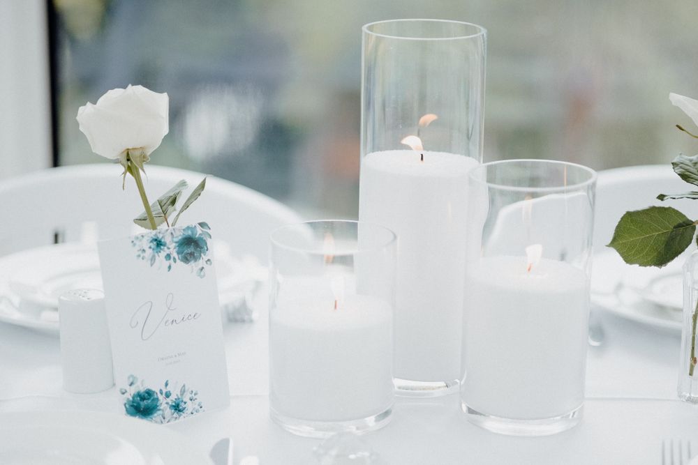 Elegant white and teal wedding table decor with clear glass vases captured by Apertured Media Auckland Wedding Photographer.