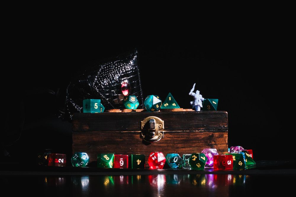 Miniature disco ball and figurines on wooden platform with colorful string lights decoration.