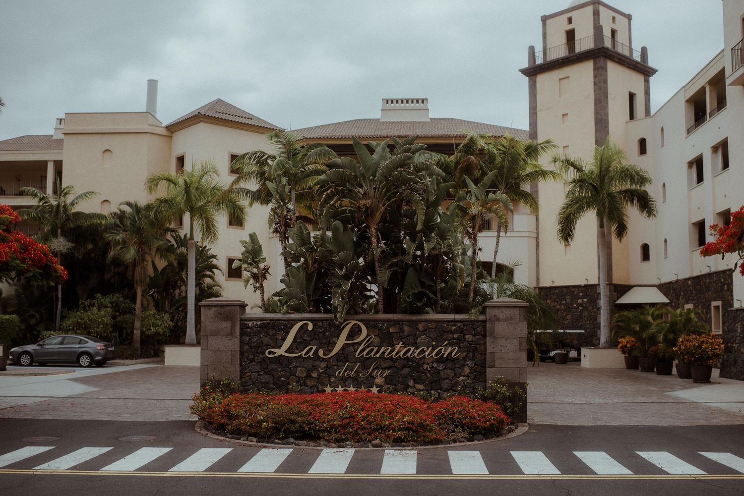 Spanish-style resort entrance with Las Palomas signage and tropical landscaping.