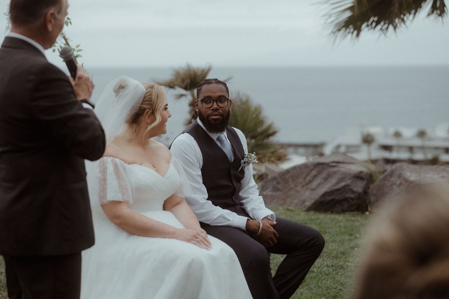 A seaside wedding ceremony with palm trees and ocean views in the background. Tenerife Wedding Photographer at Hotel Vincci La Plantación