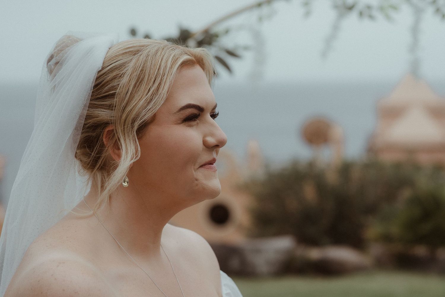 Side profile view of a bride with veil against a coastal background. Tenerife Wedding Photographer at Hotel Vincci La Plantación del Sur