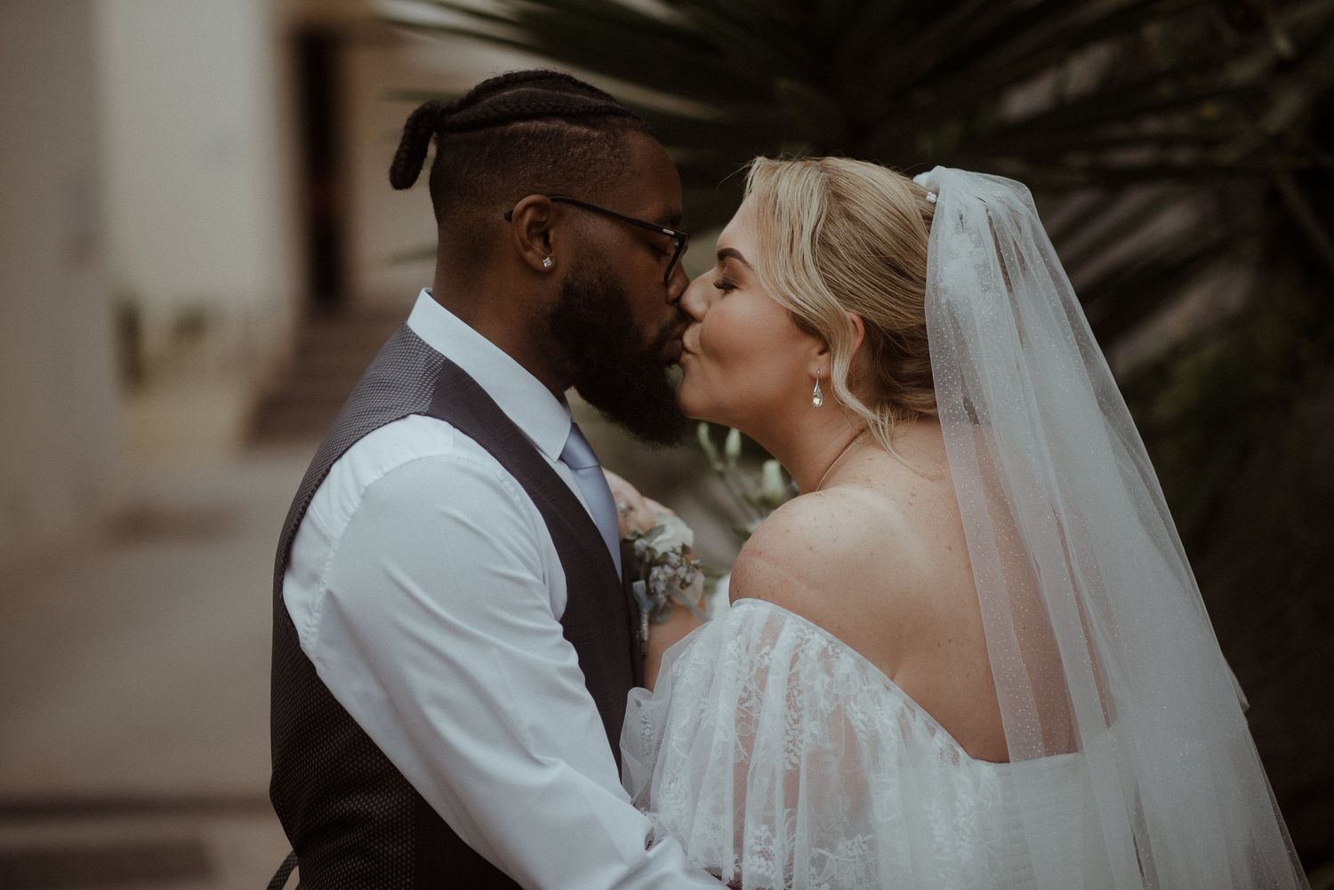 Close up romantic moment between newlyweds sharing an intimate moment at their wedding.