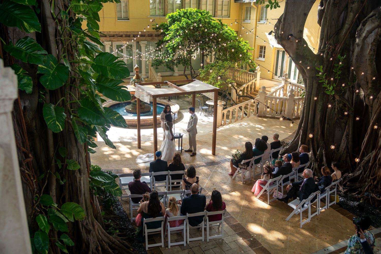 Elegant ceremony under banyan trees at The Addison, a top Boca Raton luxury wedding venue.