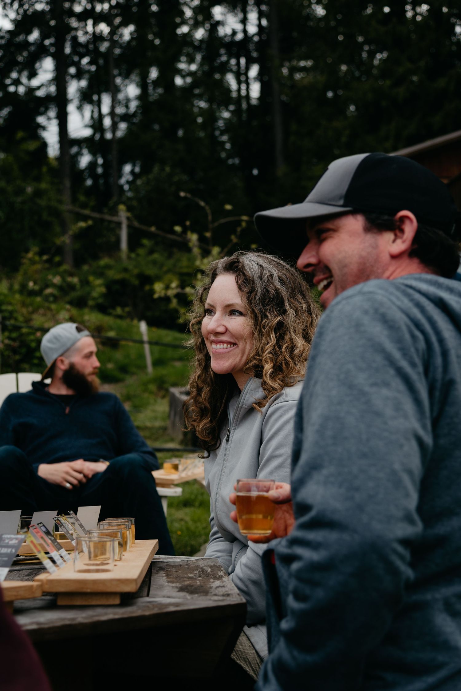 people smiling while holding glasses of cider at Ciderworks on Salt Spring Island