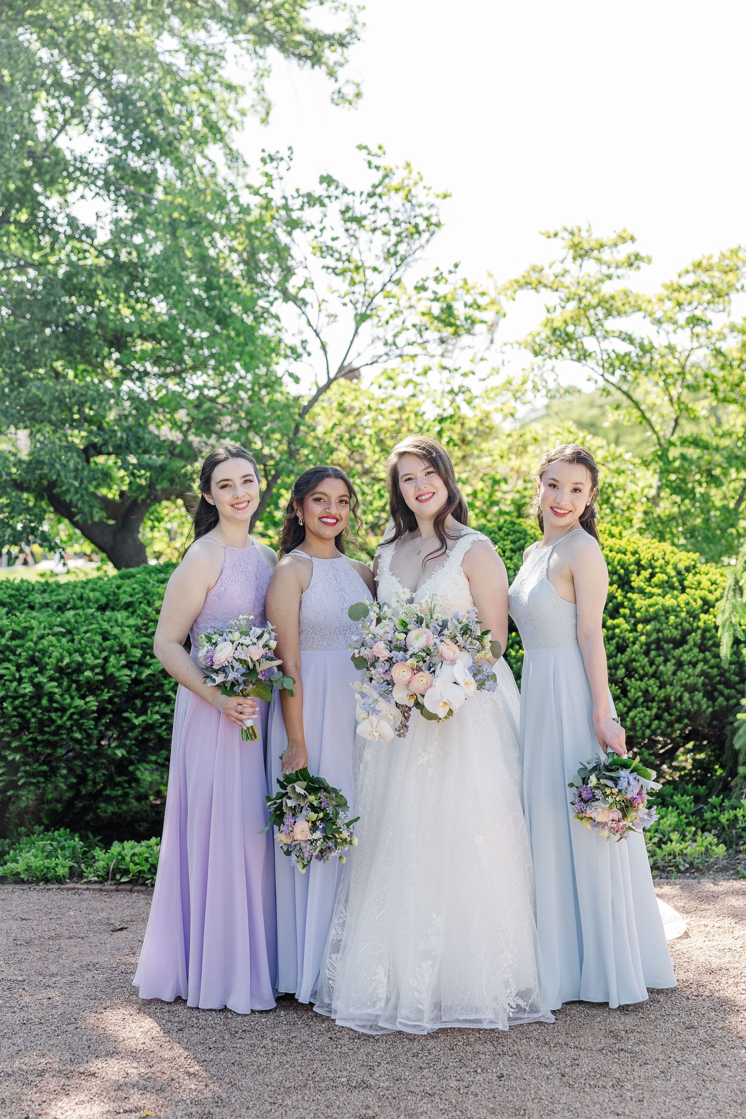 A pastel bouquet featuring soft pink and lavender roses with delicate greenery and eucalyptus arranged in romantic style.