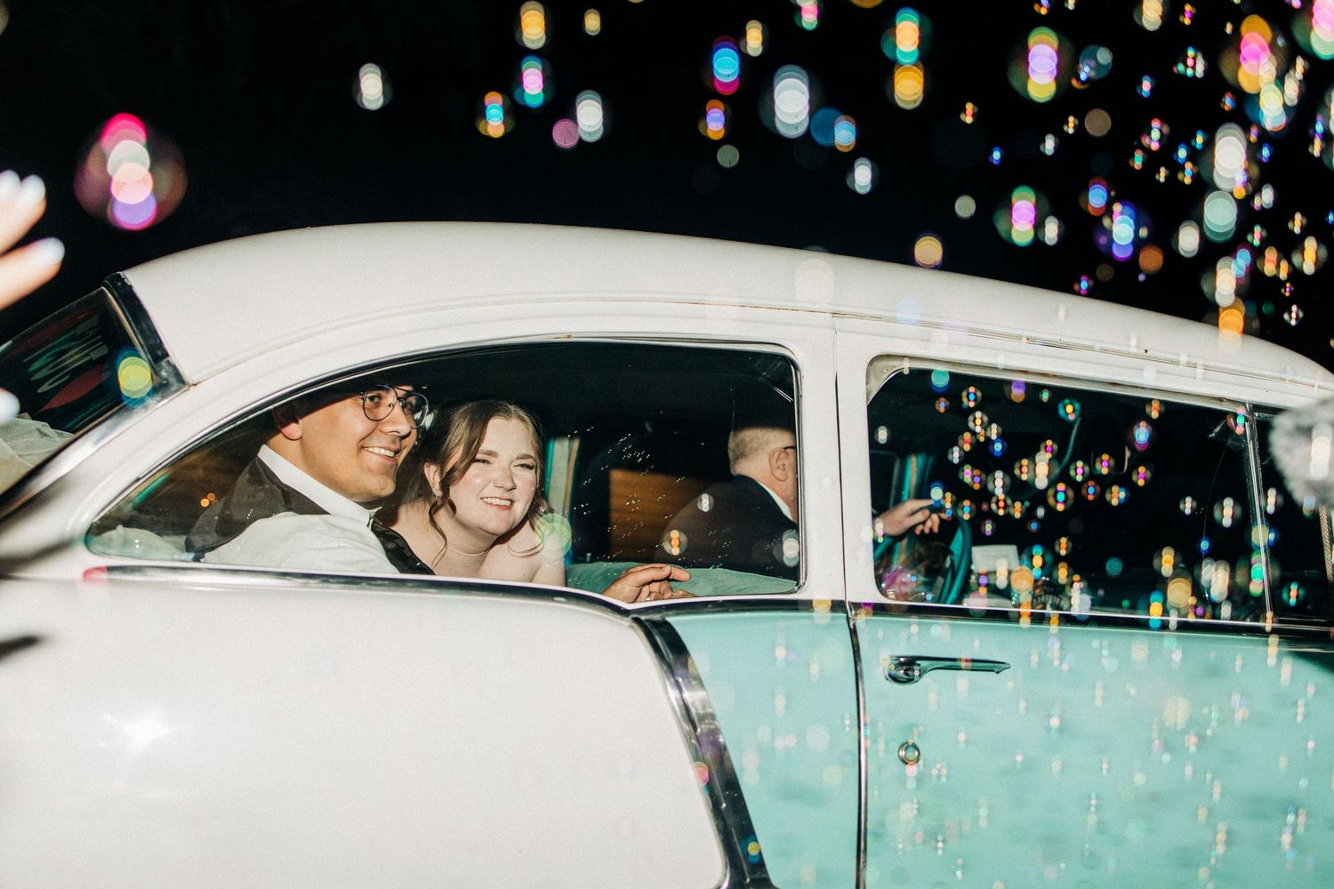 A series of car photos with bokeh lights showing someone entering a white vehicle at nighttime.