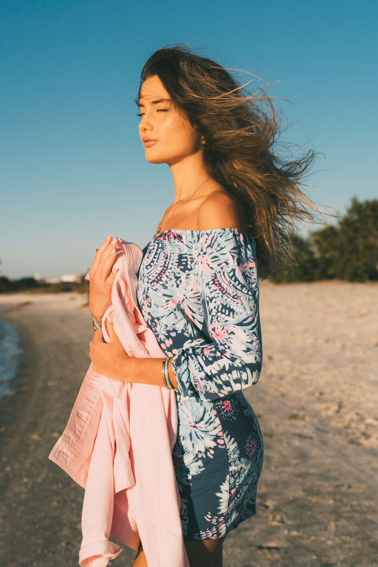 Sun-kissed model on Tampa beach during golden hour fashion shoot