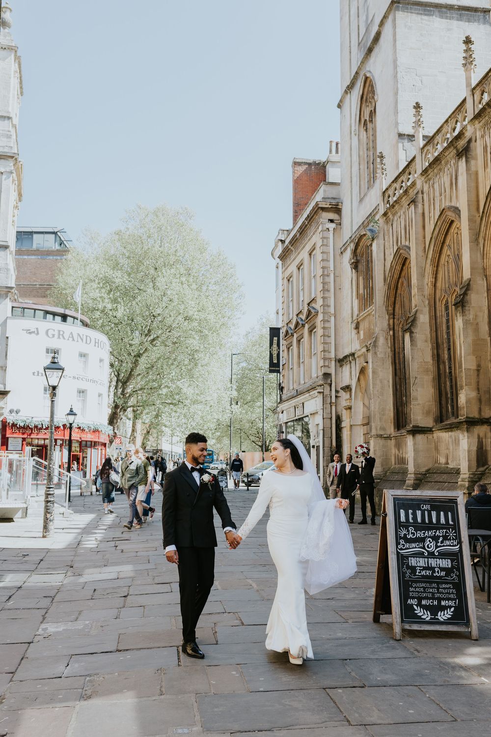 A series of romantic wedding photographs showing a couple on a historic stone street lined with Gothic architecture.