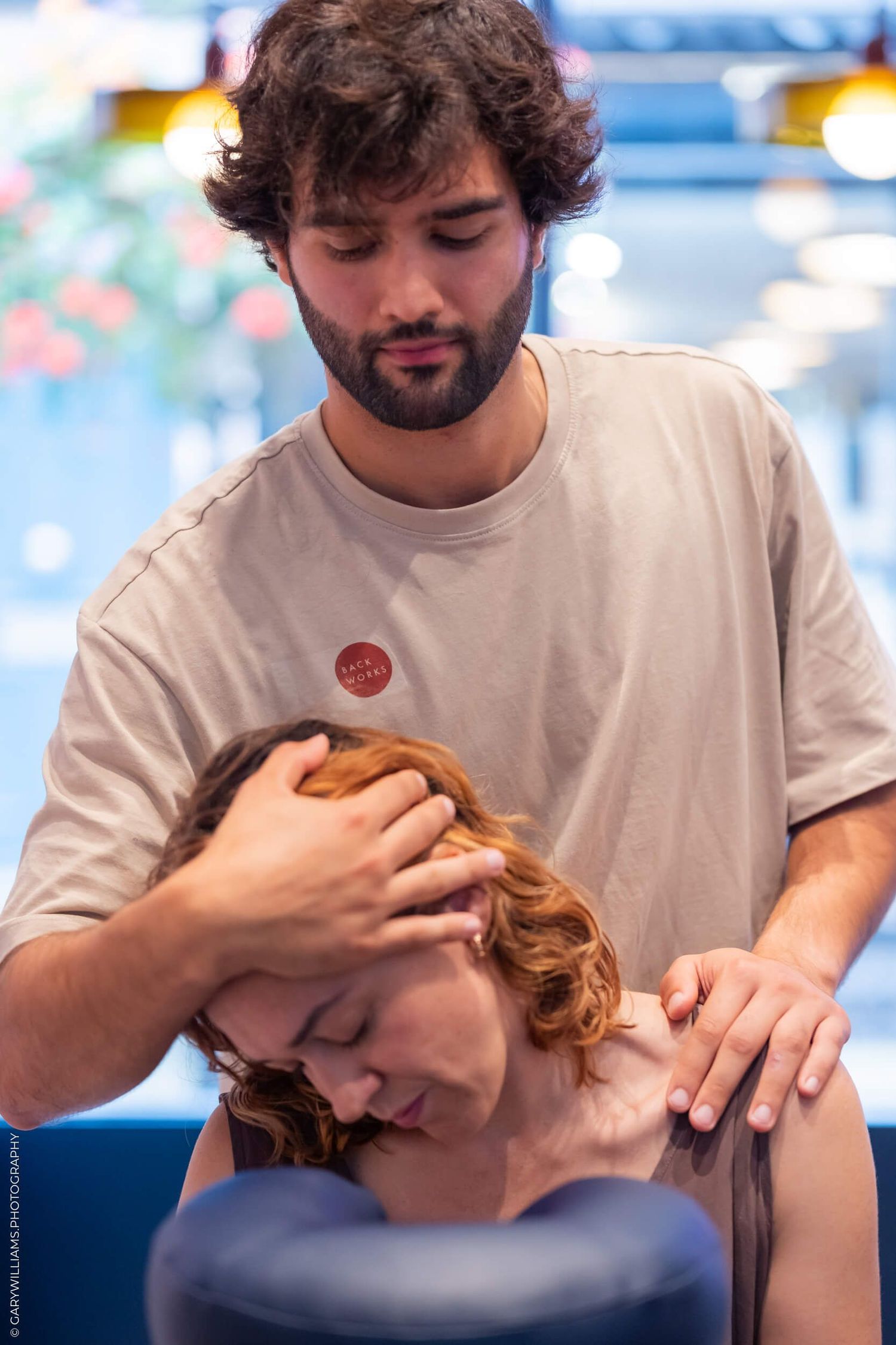 A massage therapist performing therapeutic treatment in a spa setting.