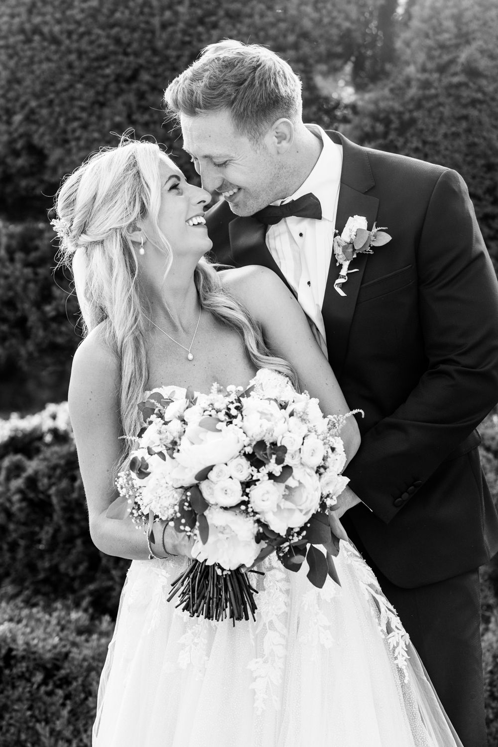 Elegant black and white wedding photography sequence showing intimate romantic moments between a couple with a white floral bouquet.