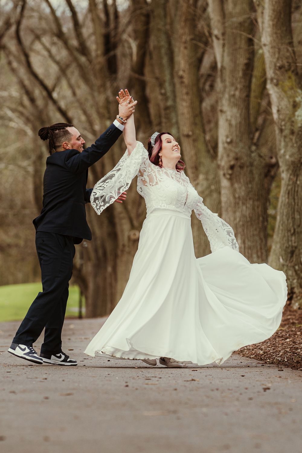 A four-panel sequence shows a playful dance dip pose in a wooded outdoor setting.