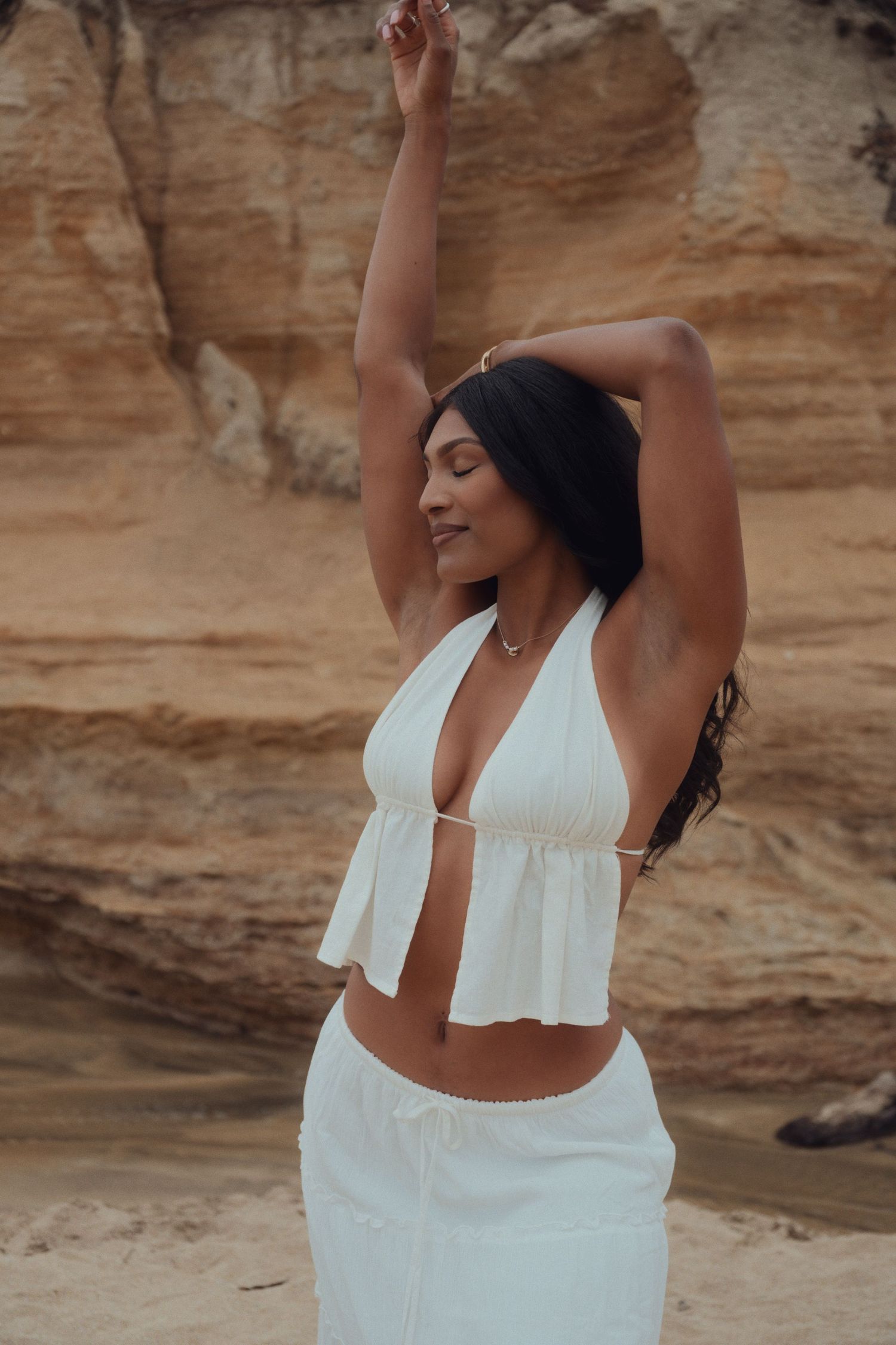 A series of cropped images showing someone in a white top dancing expressively against a rocky desert backdrop.