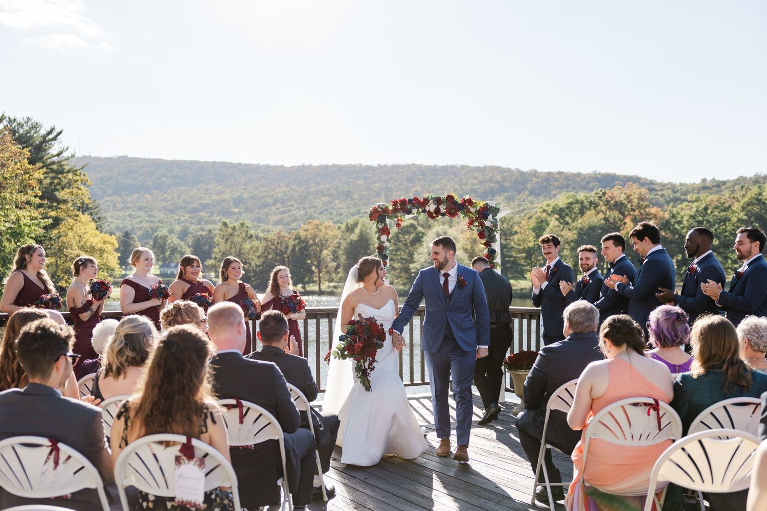 A romantic kiss captured through flowing white wedding veil during an outdoor ceremony.